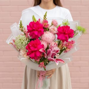 Spoil them with our Fuchsia Fantasy Bouquet this Valentine's Day! A stunning mix of hot pink roses, lilies, and more. Order now for a wow-worthy delivery!