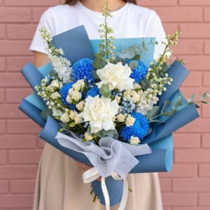 The perfect unique Valentine's gift! Our Sapphire Skies Bouquet is a stunning mix of blue chrysanthemums & white roses. Order for delivery in St Albans.